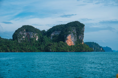 Towering limestone cliffs rising from turquoise sea water
