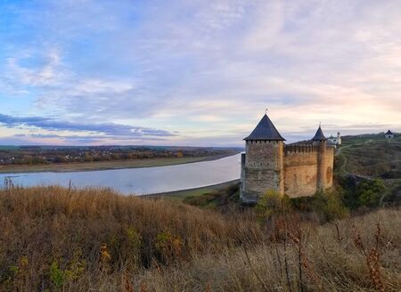 Castle near the river at sunset Photeの写真素材
