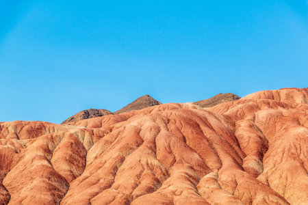 blue sky over the red clay mountainsの写真素材