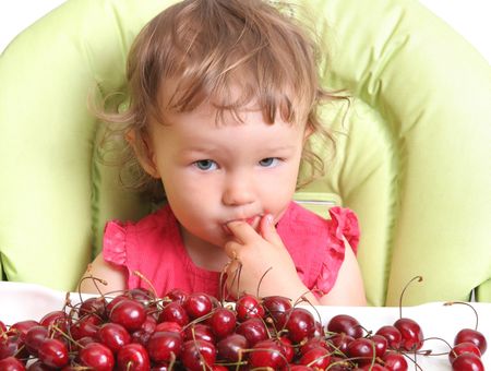 child tastes cherryの写真素材