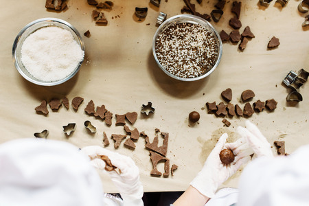Young girls making chocolate candy. Sweets for celebrationの写真素材