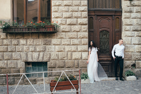 A young, sympathetic couple walks through the streets of the city. Loveの写真素材