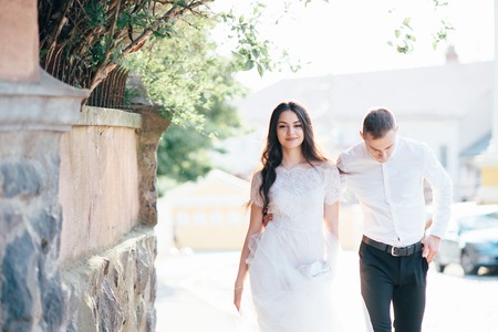 A young, sympathetic couple walks through the streets of the city. Loveの写真素材