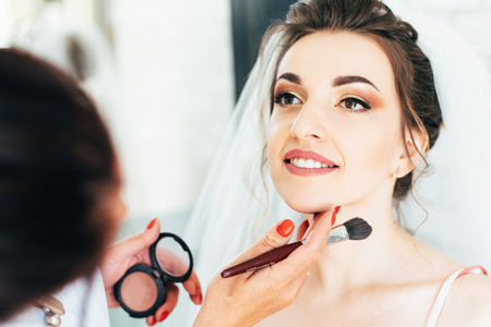 Beautiful happy bride with wedding hairstyle bright makeup in bridal dayの写真素材