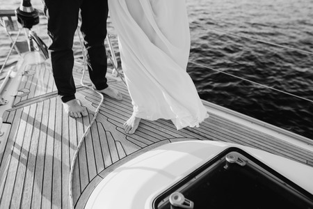 A couple of men and women spend time on a small ship in the middle of a charming lake.の写真素材