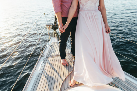 A couple of men and women spend time on a small ship in the middle of a charming lake.の写真素材
