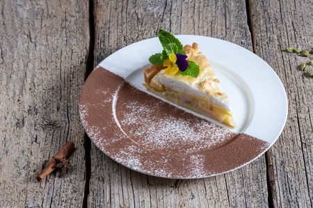 A piece of appetizing cake with apples, homemade prepared on a white plate.の写真素材