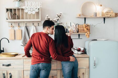 Man and woman hugging in a kitchen and have fun spending time.の写真素材
