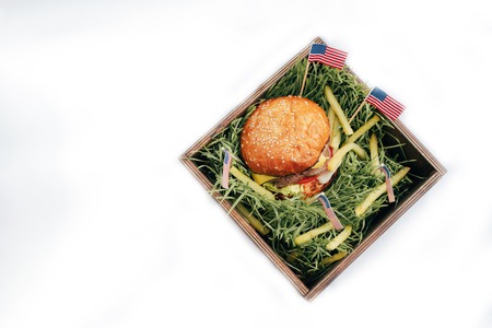 Delicious burger with bacon, tomato, lettuce, cheese, onion on dark white backgroundの写真素材