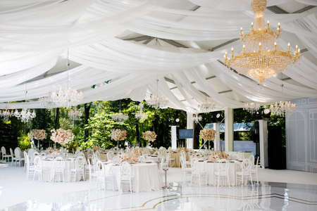 Festive wedding table setting with flowers, napkins, cutlery, glasses, bright summer table decor. Wedding decorの写真素材