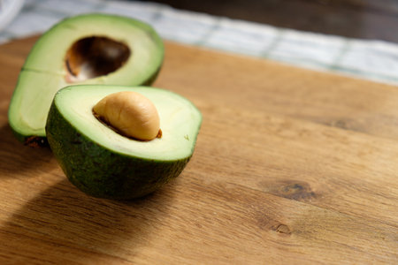 Avocado on a wooden cutting board. Close-up, selective focus.の写真素材