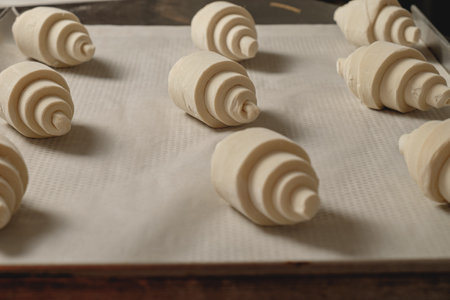 Delicious crescent rolls rising on a baking tray in a cozy kitchen filled with warm aromas of bread...