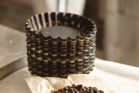 Stacked baking molds and fresh coffee beans create an atmosphere of culinary creativity and warmth...