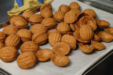 Delightful baked treats resembling acorns rest on a tray, ready to bring joy at the upcoming gathering of friends and family during a cozy evening in fallの写真素材