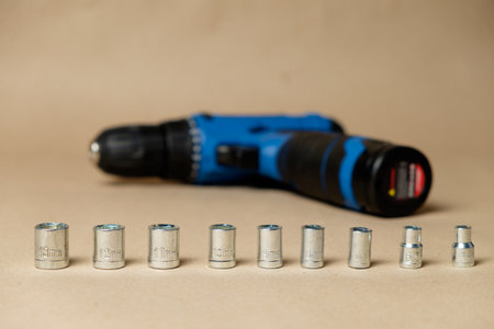 Set of hexagonal sockets featuring battery-operated screwdriverの写真素材