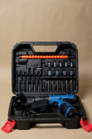 Compact tool case with electric screwdriver and home repair accessoriesの写真素材