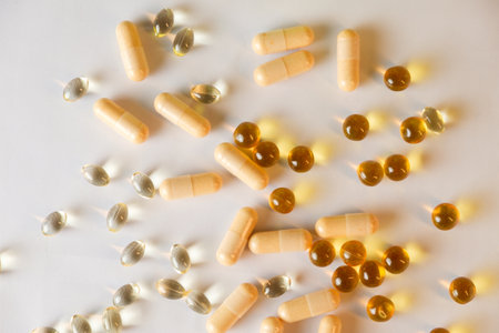 Colorful array of supplements spread across a clean surfaceの写真素材