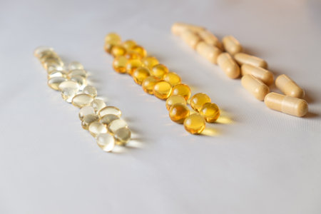 Variety of dietary supplements arranged in colorful rows on a smooth surfaceの写真素材