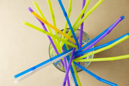 Colorful straws in a glass create an artistic display of vibrant huesの写真素材