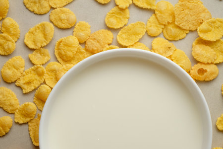 Morning delight of crunchy corn flakes and creamy milk in a vibrant settingの写真素材
