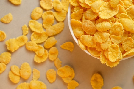 Enjoying a morning with crunchy corn flakes in a cozy kitchen settingの写真素材