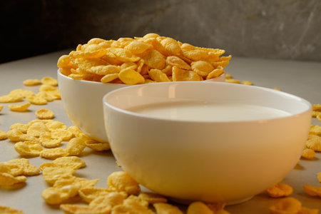 Crunchy corn flakes served with creamy milk on a breakfast table