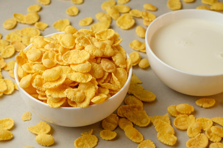 Crispy corn flakes and creamy milk in a cozy kitchen morningの写真素材