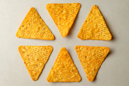 Delicious triangular snack arranged in a playful display on a neutral backgroundの写真素材