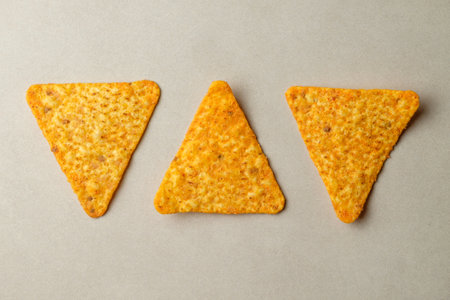 Delightful nacho chips arranged in playful geometric patterns and vibrant colorsの写真素材