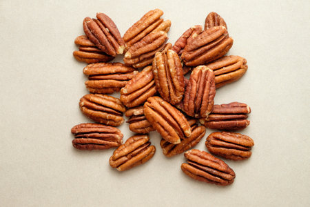 Pecan nuts scattered on a smooth surface create a rustic visual delightの写真素材