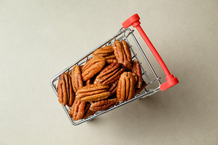 Delicious pecans in a shopping cart resting on a neutral backgroundの写真素材