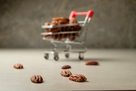 Savoring pecan nuts in a rustic kitchen with a playful cartの写真素材