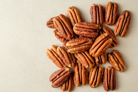 Harvested pecan nuts spread out for a rustic autumn display and culinary delightの写真素材