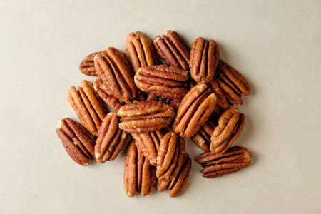 Delicious pecan nuts scattered on a warm, inviting countertopの写真素材