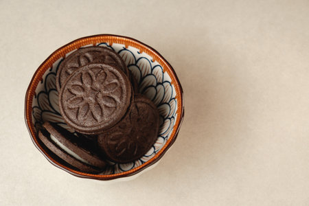 Delightful baked treats arranged in a decorative bowl on a white backdropの写真素材