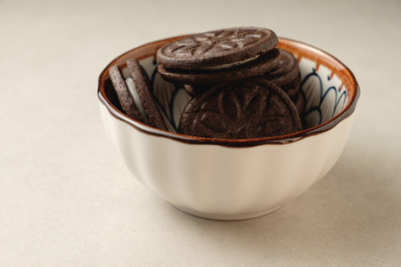 Delightful chocolate cookies resting in a decorative bowlの写真素材