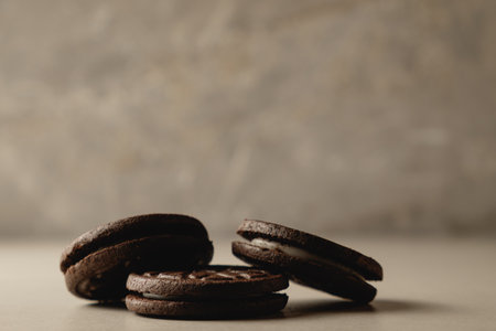 Delightful chocolate cookies resting on a smooth surface in soft lightingの写真素材
