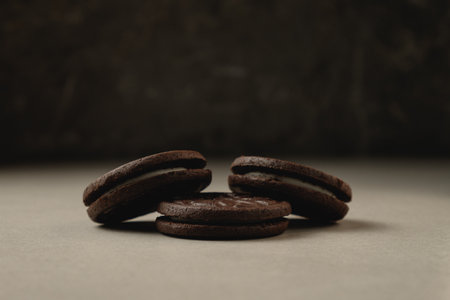 Indulging in dark chocolate delights with creamy filling at cozy gatheringの写真素材