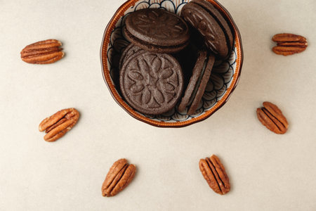 Deliciously crafted chocolate cookies and pecans in an artistic arrangementの写真素材