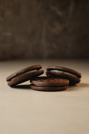 Delighting in rich chocolate cookies on a minimalist tableの写真素材