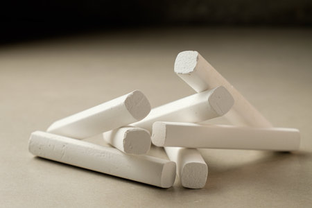 White chalk pieces arranged artistically on a smooth surface in soft lightの写真素材
