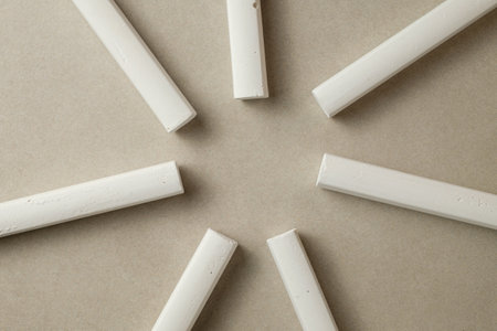 Creative arrangement of chalk pieces on a smooth surface in natural lightの写真素材