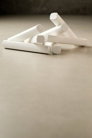 Chalk pieces resting on a smooth surface during a creative dayの写真素材