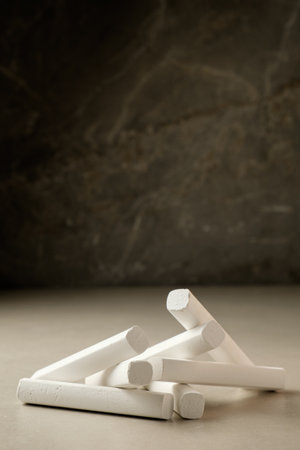 White chalk sticks arranged artistically on a smooth surface in soft lightの写真素材