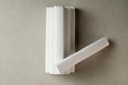 Creative assembly of white chalk pieces forming unique shapes in natural lightの写真素材