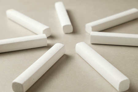 Chalk pieces arranged in a circular pattern on a neutral backgroundの写真素材