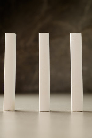 Three white chalk sticks arranged artistically on a creative workspaceの写真素材