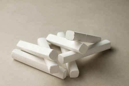 Stacked white chalk pieces on a neutral background, perfect for art creativityの写真素材
