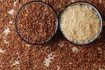 Organic brown rice and white rice displayed in traditional bowlsの写真素材