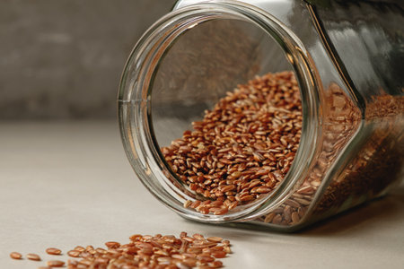 Discovering the beauty of organic grains spilled from a glass jarの写真素材